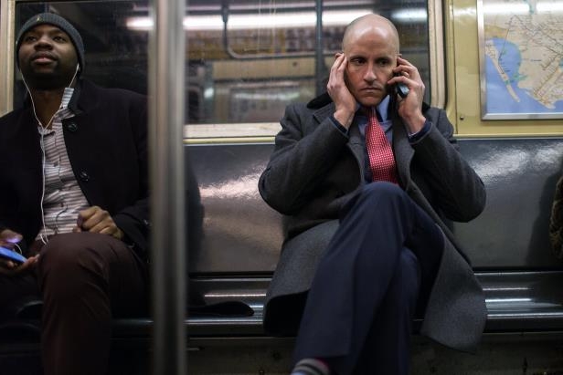 Commuters using their phones